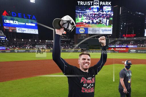 Atlanta Braves Freddie Freeman celebrates after Game 4 of a baseball National League Division Series against the Milwaukee Brewers, Tuesday, Oct. 12, 2021, in Atlanta. The Atlanta Braves won 5-4 to advance to the NLCS. (AP Photo/John Bazemore)