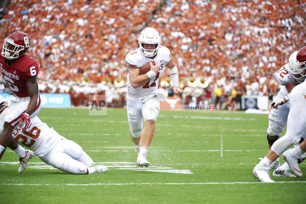 Cooper Neill Texas quarterback Sam Ehlinger (11) scrambles for a 9-yard touchdown against Oklahoma during the first half of an NCAA college football game at the Cotton Bowl, Saturday, Oct. 6, 2018, in Dallas. (AP Photo/Cooper Neill)