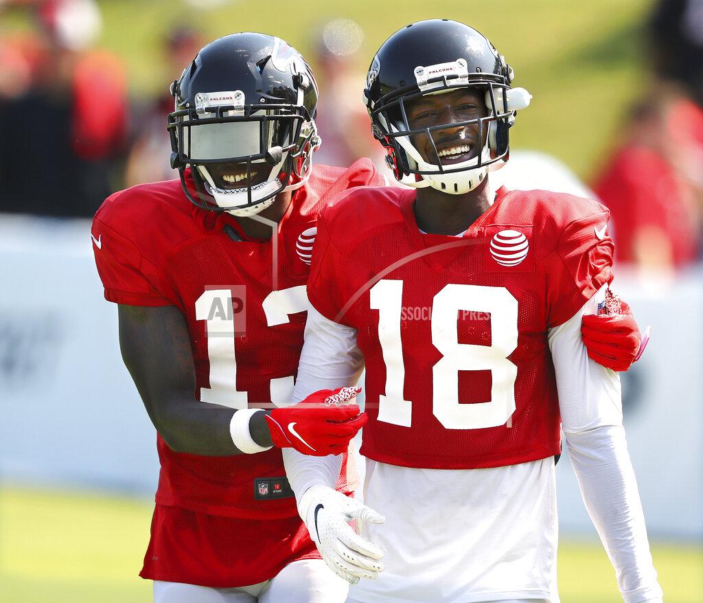 Compton@Ajc.com Atlanta Falcons wide receiver Calvin Ridley (18) gets some encouragement from wide receiver Christain Blake after catching a pass during an NFL football team practice in Flowery Branch, Ga., Monday, July 29, 2019. (Curtis Compton/Atlanta Journal-Constitution via AP)