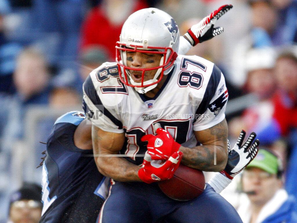 John Russell FILE - In this Dec. 31, 2006, file photo, New England Patriots wide receiver Reche Caldwell (87) catches a pass for a 62-yard touchdown ahead of Tennessee Titans cornerback Reynaldo Hill in the third quarter of an NFL football game in Nashville, Tenn. Caldwell, the former University of Florida and NFL receiver, was fatally shot Saturday, June 6, 2020, in his hometown. Caldwell's mother, Deborah, did not return phone messages left by The Associated Press on Sunday, but confirmed her son's death to the Tampa Bay Times. (AP Photo/John Russell, File)