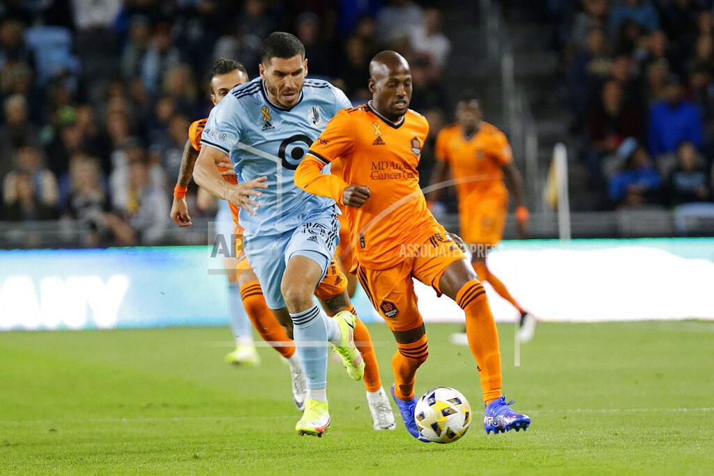 Andy Clayton-King Houston Dynamo midfielder Fafa Picault (10) controls the ball in front of Minnesota United defender Michael Boxall (15) during the first half of an MLS soccer match Saturday, Sept. 25, 2021, in St. Paul, Minn. (AP Photo/Andy Clayton-King)