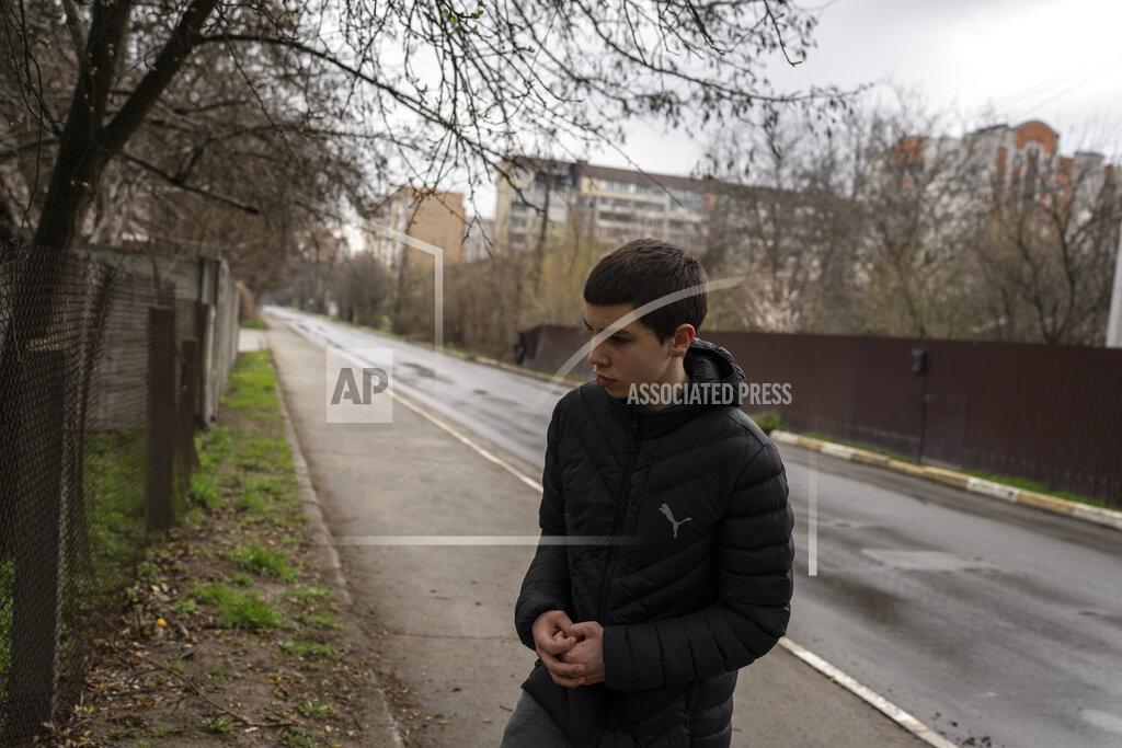 Petros Giannakouris Yura Nechyporenko, 15, stands at the scene were his father was executed, in Bucha, on the outskirts of Kyiv, Ukraine, on Thursday, April 21, 2022. The teen survived an execution attempt by Russian soldiers while his father was killed, and now his family seeks justice. (AP Photo/Petros Giannakouris)