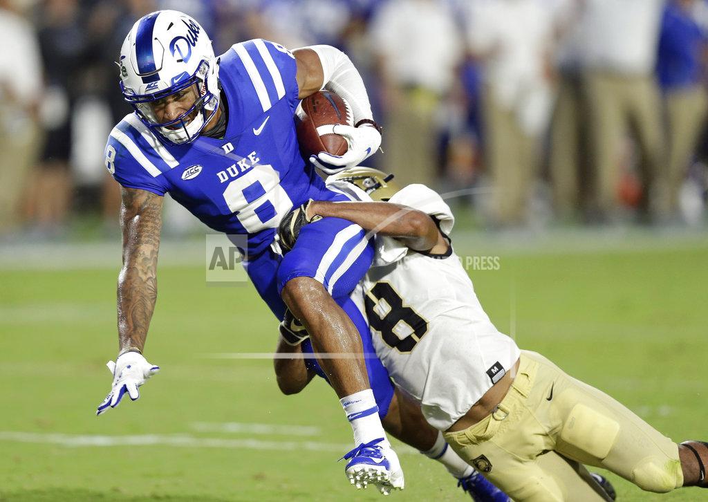 Gerry Broome Duke's Aaron Young, left, is tackled by Army's Javhari Bourdeau following a pass reception during the first half of an NCAA college football game in Durham, N.C., Friday, Aug. 31, 2018. (AP Photo/Gerry Broome)