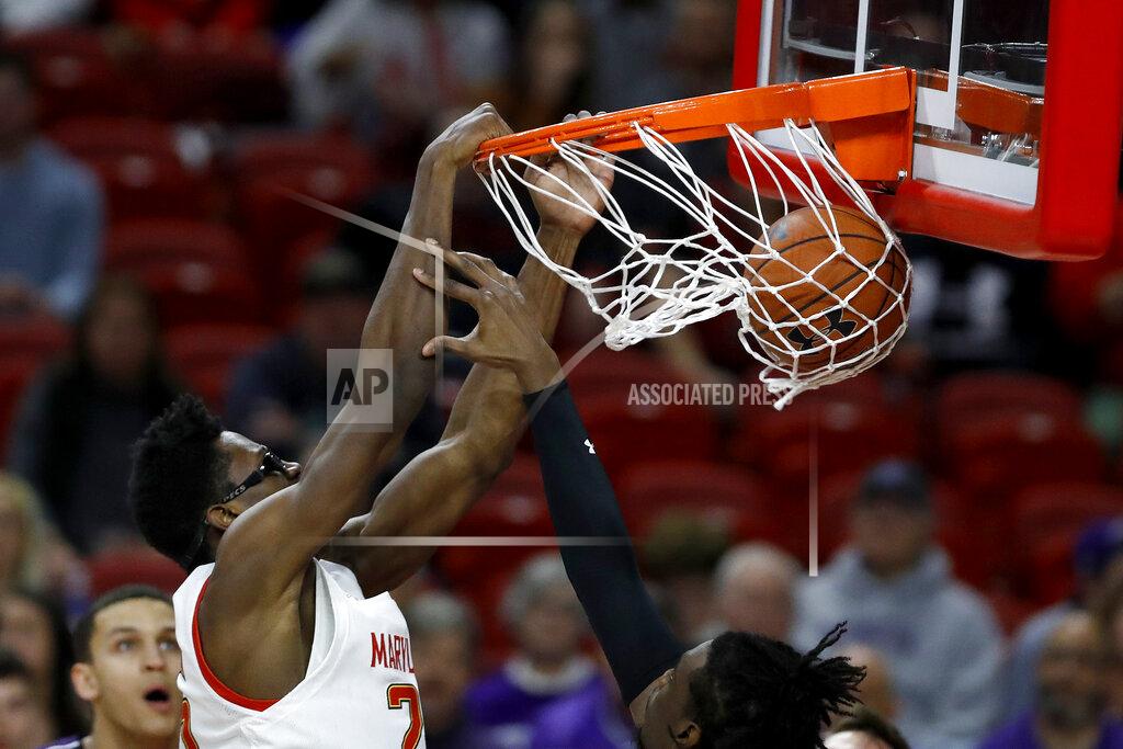 Julio Cortez Maryland forward Jalen Smith, left, dunks on Northwestern forward Jared Jones during the first half of an NCAA college basketball game, Tuesday, Feb. 18, 2020, in College Park, Md. (AP Photo/Julio Cortez)
