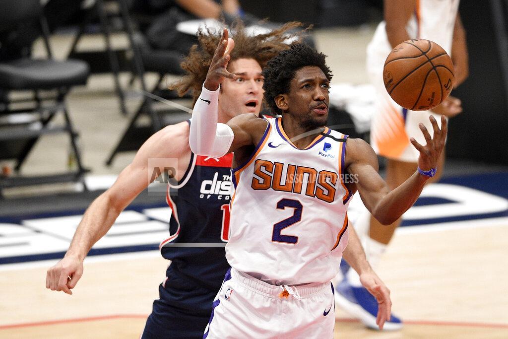 Nick Wass Phoenix Suns guard Langston Galloway (2) reaches for the ball in front of Washington Wizards center Robin Lopez, back, during the first half of an NBA basketball game, Monday, Jan. 11, 2021, in Washington. (AP Photo/Nick Wass)