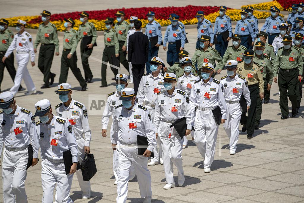 Mark Schiefelbein Military delegates arrive for the closing session of China's National People's Congress (NPC) at the Great Hall of the People in Beijing, Thursday, May 28, 2020. China’s legislature endorsed a national security law for Hong Kong on Thursday that has strained relations with the United States and Britain and prompted new protests in the territory. (AP Photo/Mark Schiefelbein)