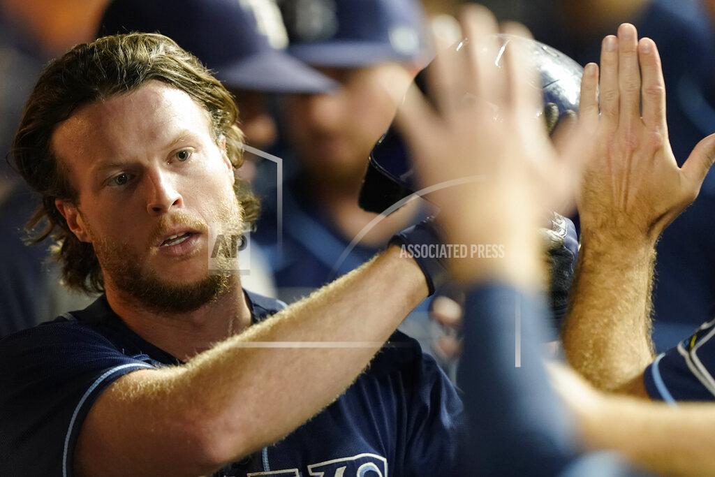 Tony Dejak Tampa Bay Rays' Brett Phillips is congratulated after scoring in the seventh inning of the team's baseball game against the Cleveland Indians, Saturday, July 24, 2021, in Cleveland. (AP Photo/Tony Dejak)