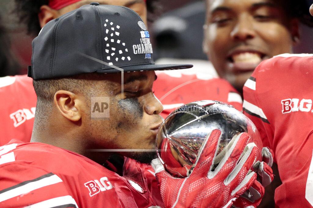 Aj Mast Ohio State's J.K. Dobbins kisses the trophy early Sunday, Dec. 2, 2018 after defeating Northwestern 45-24 in the Big Ten championship NCAA college football game in Indianapolis. Ohio State won 45-24. (AP Photo/AJ Mast)