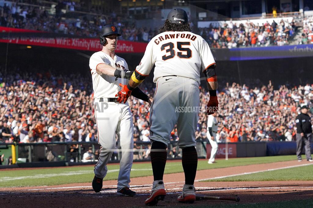 Jeff Chiu San Francisco Giants' Mike Yastrzemski, left, celebrates with Brandon Crawford after both scored on a two-run triple hit by Steven Duggar during the second inning of a baseball game against the Los Angeles Dodgers in San Francisco, Sunday, Sept. 5, 2021. (AP Photo/Jeff Chiu)