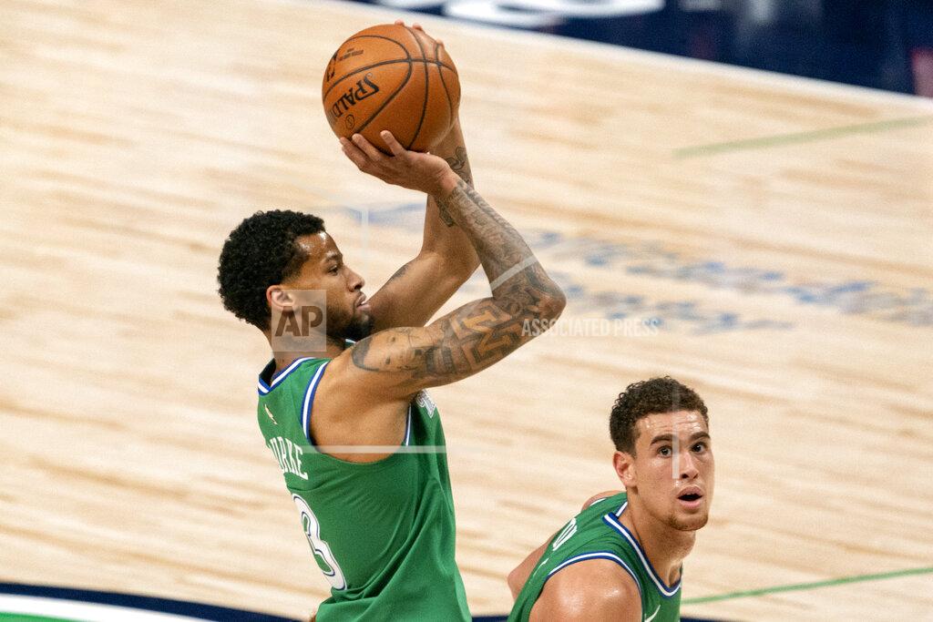 Jeffrey Mcwhorter Dallas Mavericks guard Trey Burke (3) shoots a three-point basket as center Dwight Powell looks on during the second half of an NBA basketball game against the Orlando Magic, Saturday, Jan. 9, 2021, in Dallas. (AP Photo/Jeffrey McWhorter)