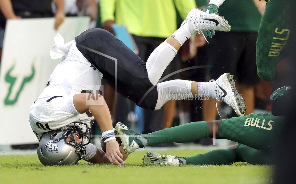 Mike Carlson UCF's quarterback McKenzie Milton goes down with an apparent knee injury after being tackled during the first half of an NCAA college football game against South Florida, Friday, Nov. 23, 2018, in Tampa, Fla. (AP Photo/Mike Carlson)