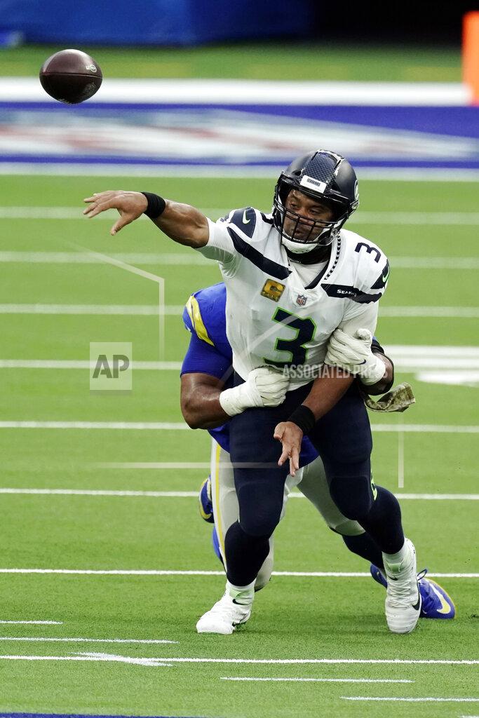 Jae C. Hong Seattle Seahawks quarterback Russell Wilson (3) throws as he is tackled by Los Angeles Rams defensive end Aaron Donald during the second half of an NFL football game Sunday, Nov. 15, 2020, in Inglewood, Calif. (AP Photo/Jae C. Hong)