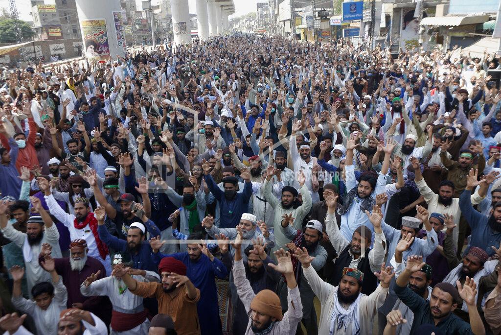 K.M. Chaudary Supporters of Tehreek-e-Labiak Pakistan, a banned Islamist party, chant slogans during a protest on the arrest of their party leader Saad Rizvi, who was demanding the government to expel French ambassador, in Lahore, Pakistan, Monday, April 19, 2021. The outlawed Pakistani Islamist political group freed 11 policemen almost a day after taking them hostage in the eastern city of Lahore amid violent clashes with security forces, the country's interior minister said Monday. (AP Photo/K.M. Chaudary)
