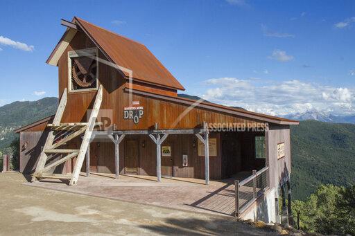 FILE - The Haunted Mine Drop is shown in this July 2017 file photo at Glenwood Caverns Adventure Park in Glenwood Springs, Colo. A report from Colorado state investigators, Friday, Sept. 24, 2021, says a 6-year-old girl who died in a fall from a theme park ride over Labor Day weekend wasn’t wearing the ride seatbelts, and operators of the vertical drop ride didn’t properly check the restraints. (Chelsea Self/Glenwood Springs Post Independent via AP, File)