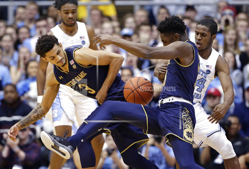 Gerry Broome North Carolina's Kenny Williams, right, reaches in on Notre Dame's TJ Gibbs as Prentiss Hubb (3) looks for the ball during the first half of an NCAA college basketball game in Chapel Hill, N.C., Tuesday, Jan. 15, 2019. (AP Photo/Gerry Broome)