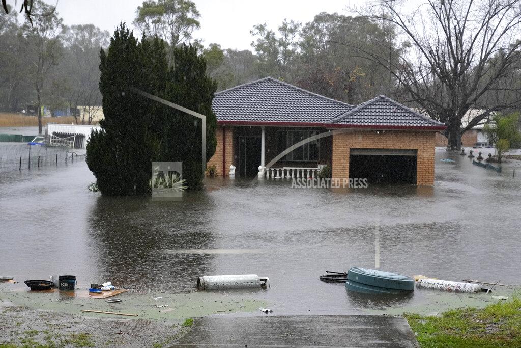 Mark Baker A house sits semi-submerged in flood waters near Richmond on the outskirts of Sydney, Australia, Monday, July 4, 2022. More than 30,000 residents of Sydney and its surrounds have been told to evacuate or prepare to abandon their homes on Monday as Australia's largest city braces for what could be its worst flooding in 18 months. (AP Photo/Mark Baker)