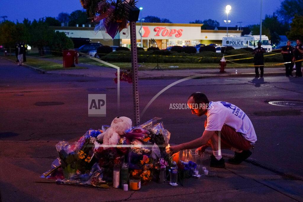 Matt Rourke FILE - A person pays his respects at a makeshift memorial outside the scene of a shooting at a supermarket in Buffalo, N.Y., Sunday, May 15, 2022. (AP Photo/Matt Rourke, File)