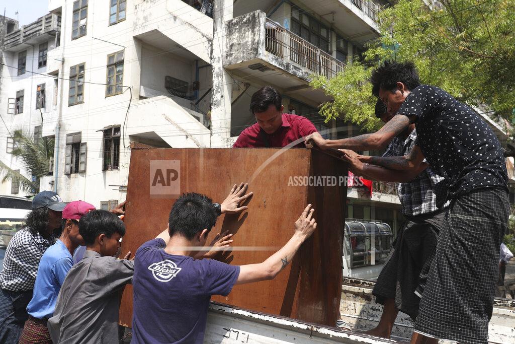 Uncredited State railway employees load furniture in to a truck after being evicted from their home Saturday, March 20, 2021, in Mandalay, Myanmar. State railway workers in Mandalay have been threatened with eviction to force them to end their support for the Civil Disobedience Movement (CDM) against military rule. (AP Photo)