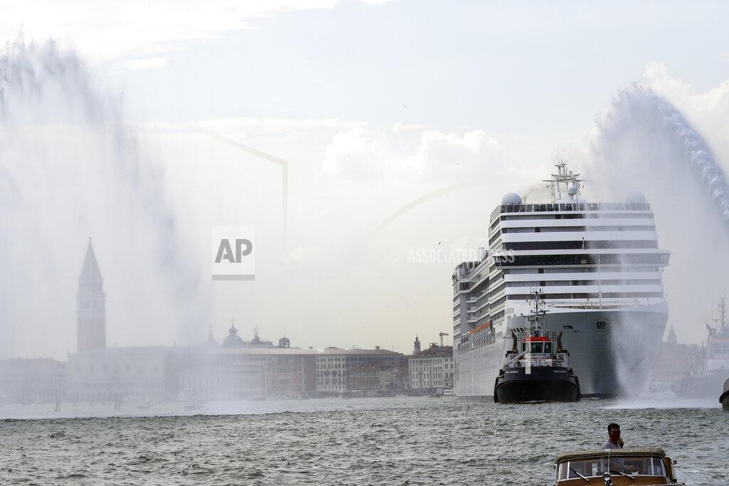 Antonio Calanni The MSC Orchestra cruise ship leaves Venice, Italy, Saturday, June 5, 2021. The 92,409-ton, 16-deck MSC Orchestra cruise ship, the first cruise ship leaving Venice since the pandemic, departed Saturday amid protests by activists demanding that the enormous ships be permanently rerouted out the fragile lagoon, especially Giudecca Canal through the city's historic center, due to environmental and safety risks. The ship passed two groups of protesters: pro-cruise advocates whose jobs depend on the industry as well as protesters who have been campaigning for years to get cruise ships out of the lagoon. (AP Photo/Antonio Calanni)