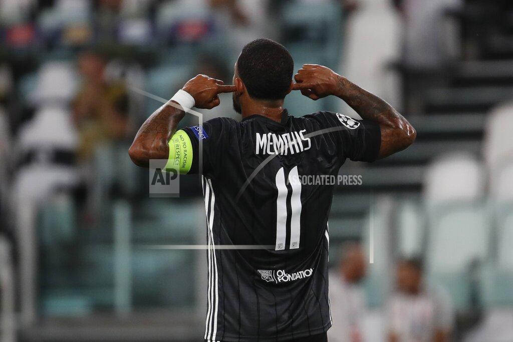 Antonio Calanni Lyon's Memphis Depay celebrates after scoring the opening goal of his team during the Champions League round of 16 second leg, soccer match between Juventus and Lyon at the Allianz stadium in Turin, Italy, Friday, Aug. 7, 2020. (AP Photo/Antonio Calanni)