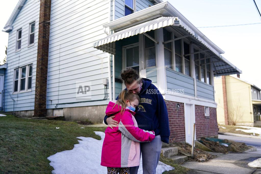 Matt Slocum Melissa Weirich, right, hugs her daughter, Kacie Thompson, 9, outside the former home of her friend, Ava Lerario, Thursday, March 11, 2021, in Lansford, Pa. On May 26, 2020, Ava; her mother, Ashley Belson, and Ava's father, Marc Lerario were found fatally shot inside the home. (AP Photo/Matt Slocum)