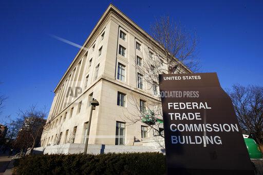 FILE - This Jan. 28, 2015, file photo, shows the Federal Trade Commission building in Washington. Federal regulators say they are cracking down on “an explosion” of businesses' use of fake reviews and other misleading messages to promote their products and services on social media. The Federal Trade Commission said, Thursday, Oct. 14, 2021, it has warned hundreds of major corporations and smaller businesses that they could face fines if they use bogus endorsements to deceive consumers. (AP Photo/Alex Brandon, File)