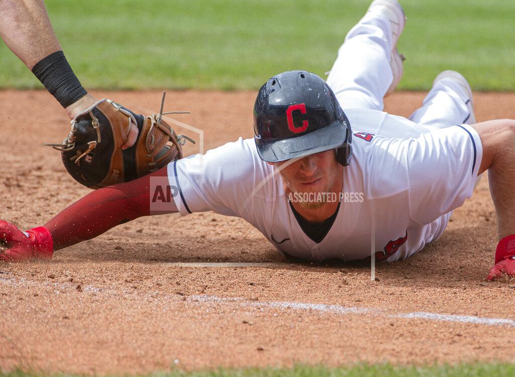 Phil Long Cleveland Indians' Myles Straw slides safely back to first base ahead of a tag by Chicago White Sox's Gavin Sheets during the third inning of a baseball game in Cleveland, Sunday, Sept. 26, 2021. (AP Photo/Phil Long)