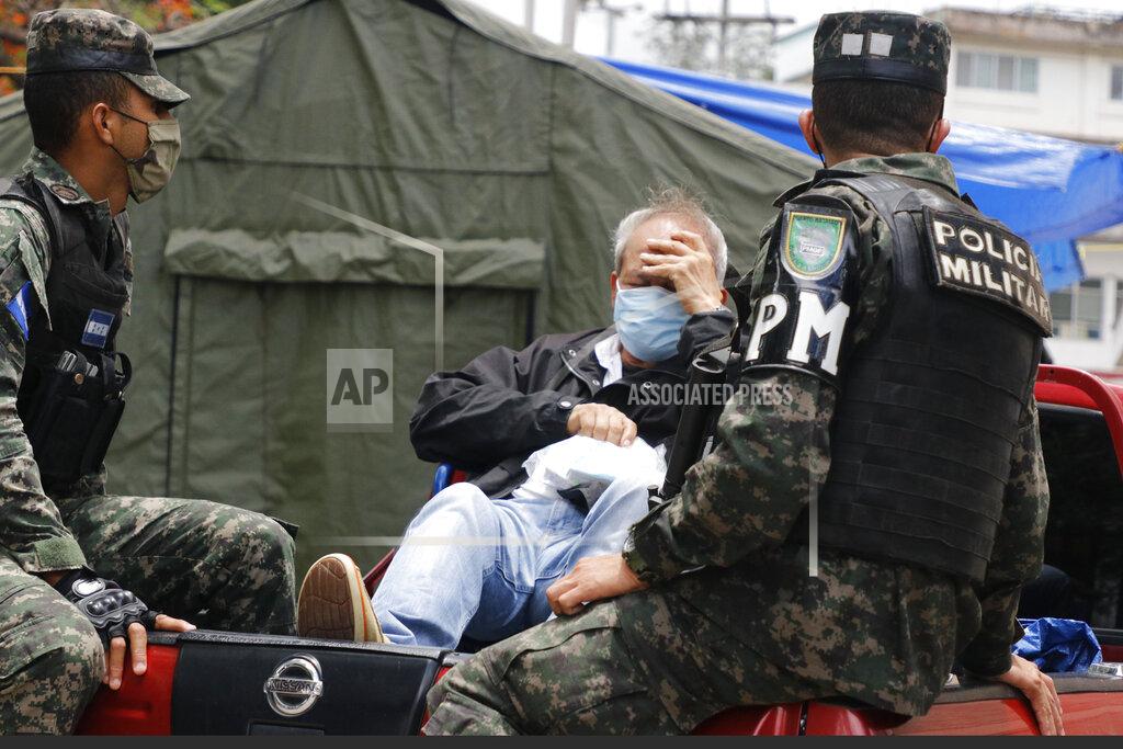 Military police bring in a person who has COVID-19 symptoms to the Hospital Escuela, in Tegucigalpa, Honduras, Thursday, June 18, 2020. The hospitalization Wednesday of Honduras' president with COVID-19 and pneumonia has drawn attention to another country struggling under the pandemic's strain as cases rise exponentially in the capital. (AP Photo/Elmer Martinez)
