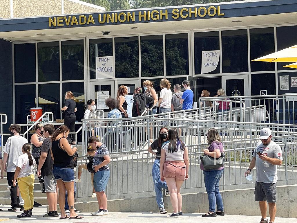 Elias Funez FILE - Nevada Union High School students, parents, and families wait in line to show proof of having been vaccinated for COVID-19, or to get tested for the virus in Grass Valley, Calif., on Saturday, Aug. 21, 2021. In most states, minors need the consent of their parents in order to be vaccinated against COVID-19. Navigating family politics in cases of differing views has been a challenge for students and organizers of outreach campaigns, who have faced blowback for directly targeting young people. (Elias Funez/The Union via AP, File)