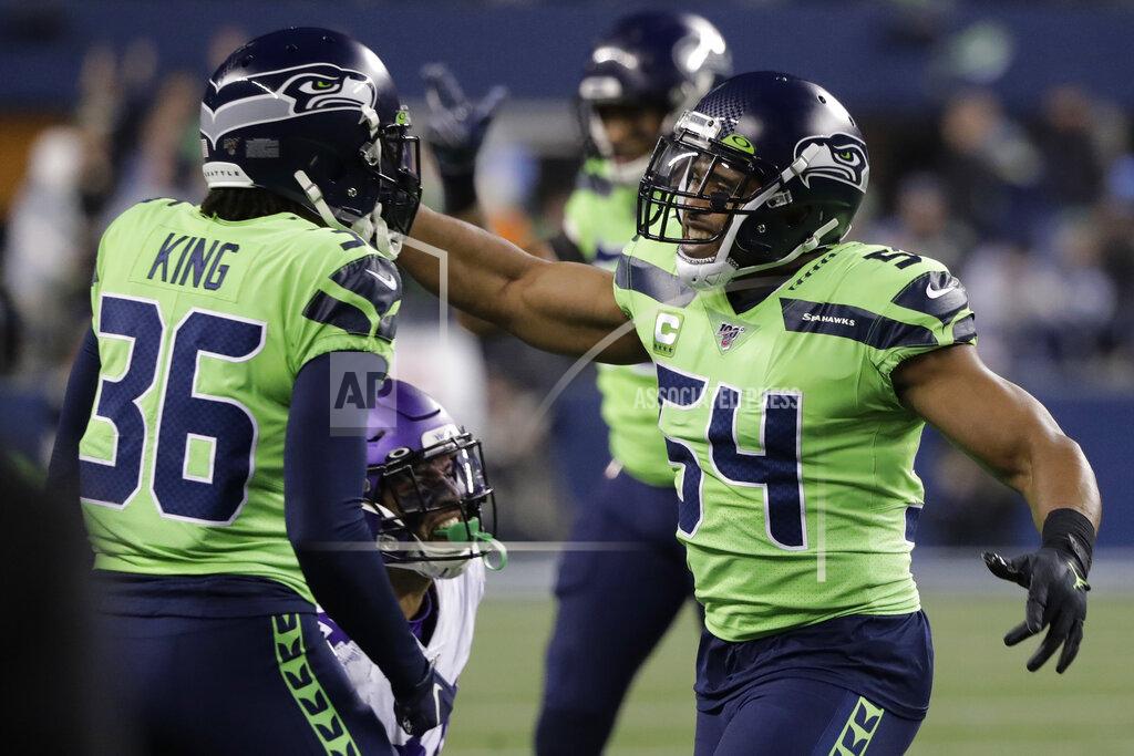 Ted S. Warren Seattle Seahawks middle linebacker Bobby Wagner, right, reacts with cornerback Akeem King (36) after the Minnesota Vikings failed to convert on a fourth-down play during the second half of an NFL football game, Monday, Dec. 2, 2019, in Seattle. The Seahawks won 37-30. (AP Photo/Ted S. Warren)