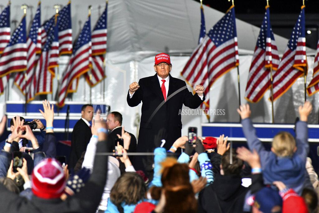 Hyosub Shin FILE -- Former President Donald Trump dances as he leaves the stage during a rally for Georgia GOP candidates at Banks County Dragway in Commerce, Ga., March 26, 2022. Trump is scheduled to speak by telephone on Monday, May 23, 2022, to support former U.S. Sen. David Perdue's challenge to Georgia Republican incumbent Gov. Brian Kemp (Hyosub Shin/Atlanta Journal-Constitution via AP)
