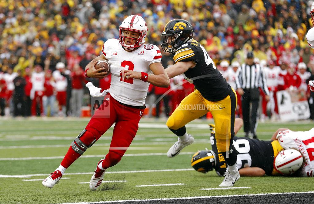 Charlie Neibergall Nebraska quarterback Adrian Martinez (2) runs from Iowa linebacker Nick Niemann during a 3-yard touchdown in the second half of an NCAA college football game, Friday, Nov. 23, 2018, in Iowa City, Iowa. Iowa won 31-28. (AP Photo/Charlie Neibergall)