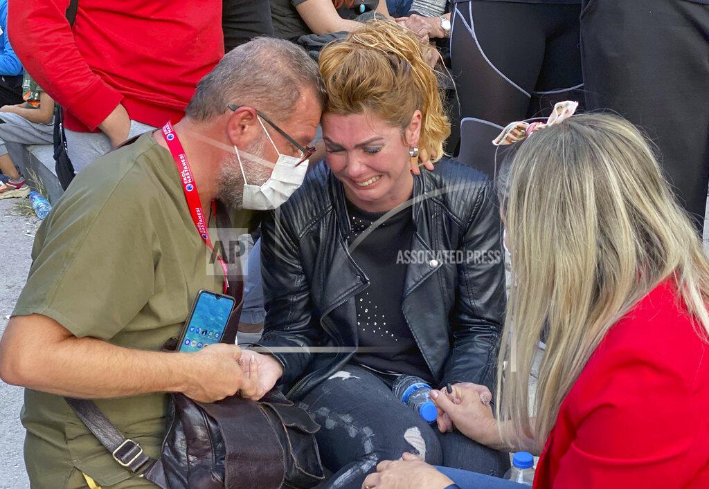 Ismail Gokmen A woman weeps as rescue workers try to save people trapped in the debris of a collapsed building, in Izmir, Turkey, Friday, Oct. 30, 2020. A strong earthquake struck Friday in the Aegean Sea between the Turkish coast and the Greek island of Samos, killing several people and injuring hundreds amid collapsed buildings and flooding, officials said.(AP Photo/Ismail Gokmen)