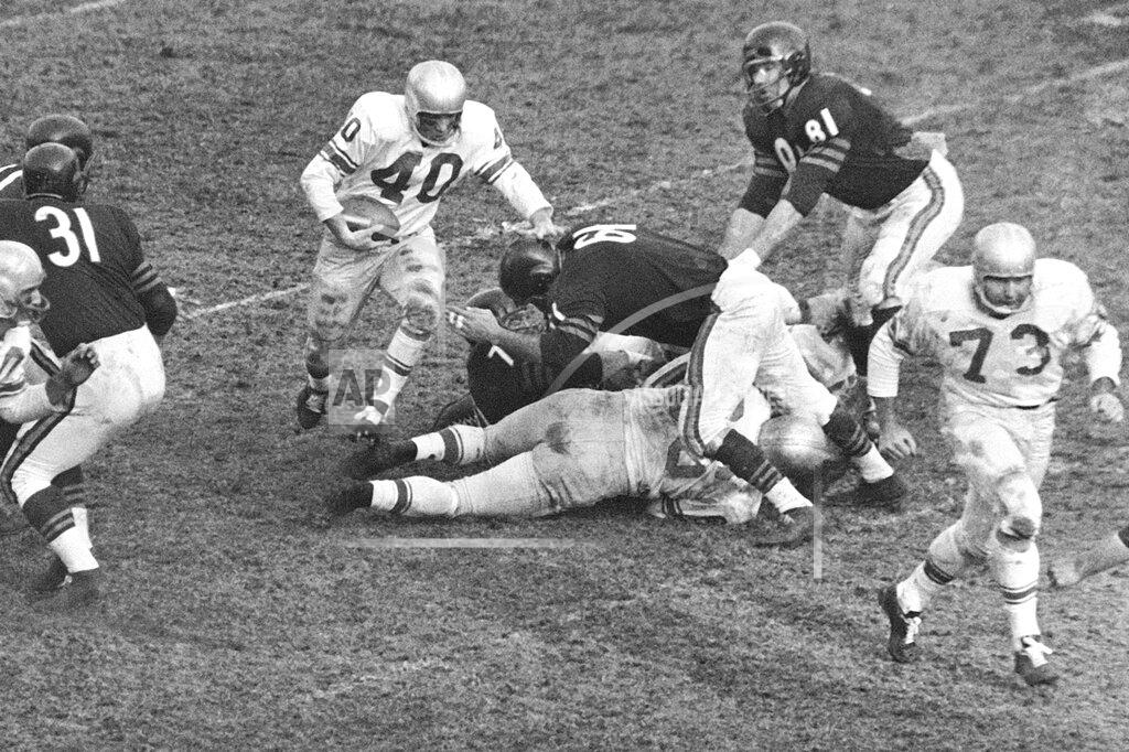 Ed Maloney FILE - In this Dec. 14, 1959, file photo, Detroit Lions back Howard Cassady (40) shoots toward a big hole in the Chicago Bears defense during the third quarter of a football game Chicago, Ill. Cassady, a Heisman Trophy winner and former NFL running back, died early Friday, Sept. 20, 2019, in Tampa, Fla., Jerry Emig, the Ohio State associate athletic director said. He was 85. Cassady played both football and baseball at Ohio State in the early 1950s, winning the Heisman Trophy in 1955. He also played 10 seasons in the NFL, mostly with the Detroit, and got the nickname "Hopalong" from local sports writers after the black-hatted Western star of the 1950s. (AP Photo/Ed Maloney, File0