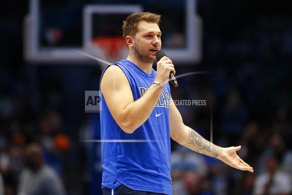 Brandon Wade Dallas Mavericks guard Luka Doncic (77) welcomes fans back to a full capacity arena before the first half of an NBA basketball game against the Houston Rockets, Tuesday, Oct. 26, 2021, in Dallas. (AP Photo/Brandon Wade)