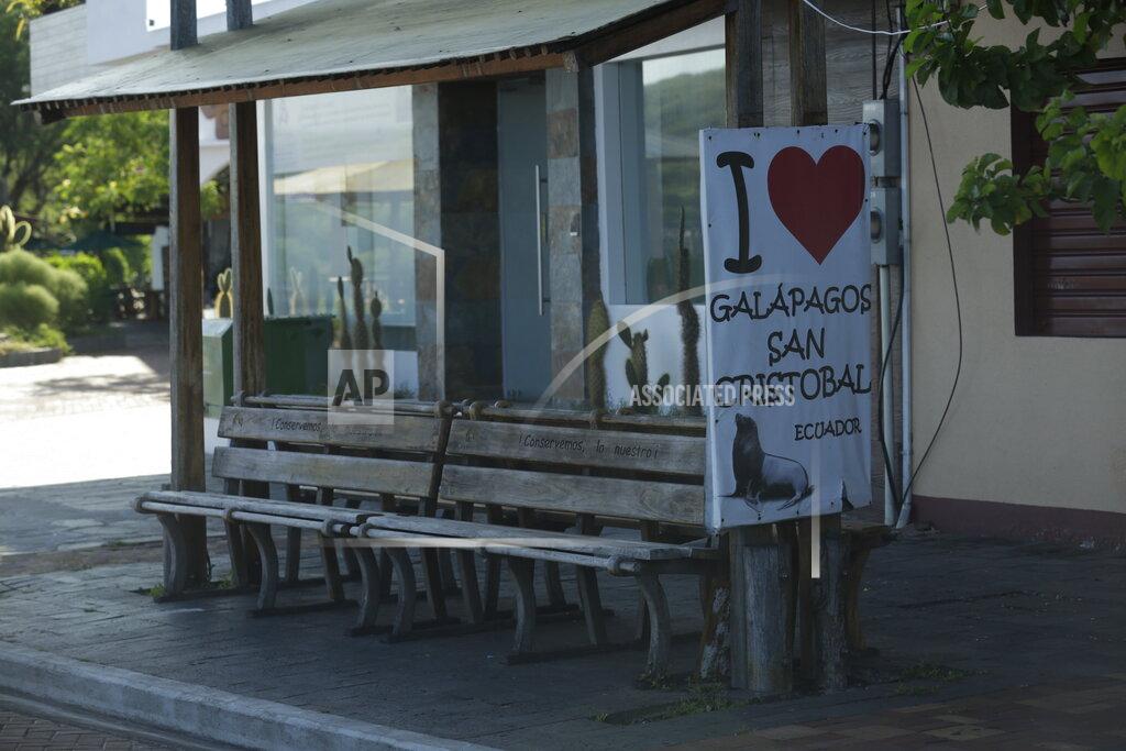 Adrian Vasquez In this May 2, 2020 photo, a pick up point for tourists sits empty amid the new coronavirus pandemic, in San Cristobal, Galapagos Islands, Ecuador. How soon the Galapagos Islands might be able to reopen is unclear. Ecuador's government is allowing for a gradual opening in three stages. But the final stage is not a full return to normal and does not call for resuming national or international flights. (AP Photo/Adrian Vasquez)