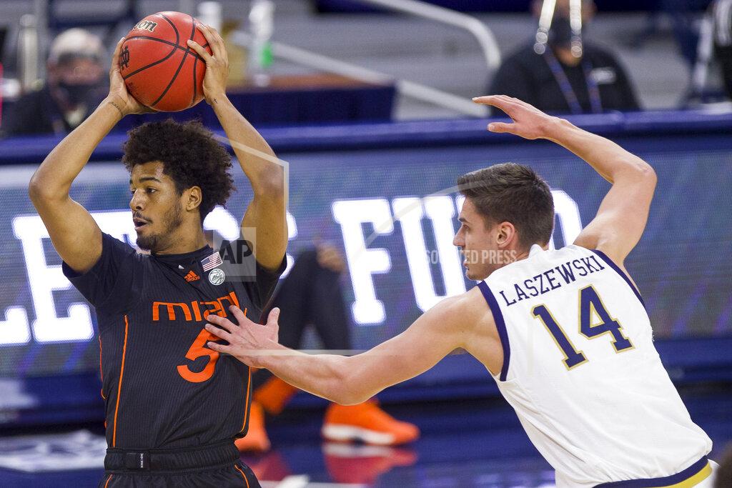 Robert Franklin Miami's Harlond Beverly (5) is pressured by Notre Dame's Nate Laszewski (14) during the first half of an NCAA college basketball game Sunday, Feb. 14, 2021, in South Bend, Ind. (AP Photo/Robert Franklin)