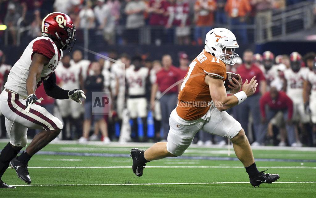 Jeffrey Mcwhorter Texas quarterback Sam Ehlinger (11) gets past Oklahoma cornerback Tre Brown (6) on a touchdown run during the first half of the Big 12 Conference championship NCAA college football game on Saturday, Dec. 1, 2018, in Arlington, Texas. (AP Photo/Jeffrey McWhorter)