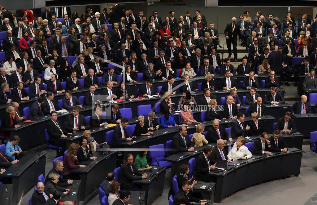 Markus Schreiber FILE - In this Wednesday, March 14, 2018 file photo, German Chancellor Angela Merkel, front row center, sits in the first row in front of the lawmakers of her center-right Christian Union block when Germany's parliament Bundestag meets to elect Angela Merkel for a fourth term as chancellor in Berlin, Germany. Before Merkel took office in 2005, 23 percent of federal lawmakers for her center-right Union bloc were women and today, the figure is 19.9 percent. (AP Photo/Markus Schreiber, File)