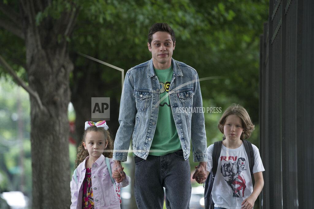 Mary Cybulski In this image released by Universal Pictures, Alexis Rae Forlenza, from left, Pete Davidson and Luke David Blumm appear in a scene from "The King of Staten Island," directed by Judd Apatow. (Mary Cybulski/Universal Pictures via AP)