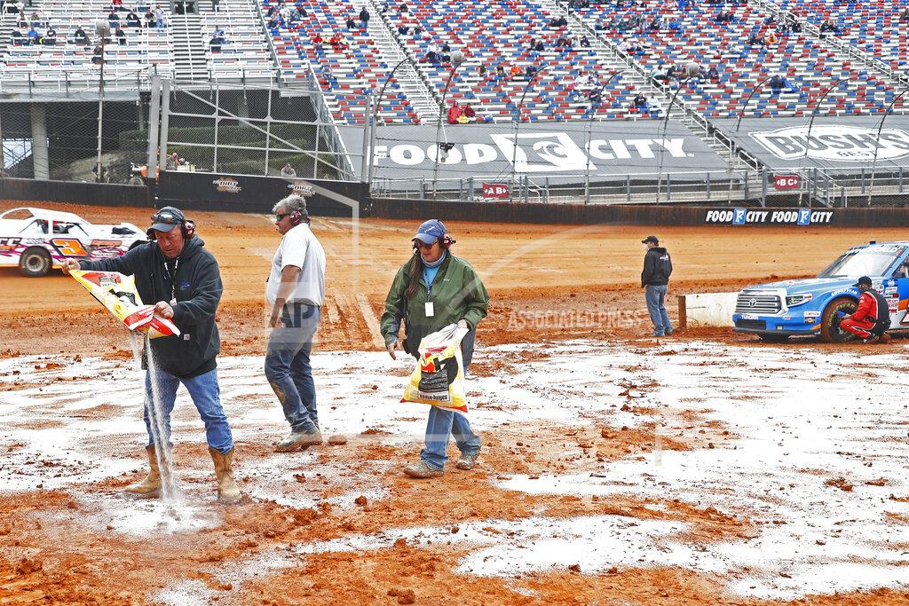 Wade Payne Safety workers spread drying agent before heat races for a NASCAR Truck Series race on Saturday, March 27, 2021, in Bristol, Tenn. (AP Photo/Wade Payne)