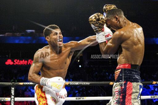 Shakur Stevenson, left, lands a punch on Jamel Herring during a junior lightweight boxing bout in Atlanta early Sunday, Oct. 24, 2021. Stevenson won the bout. (AP Photo/Ben Gray)