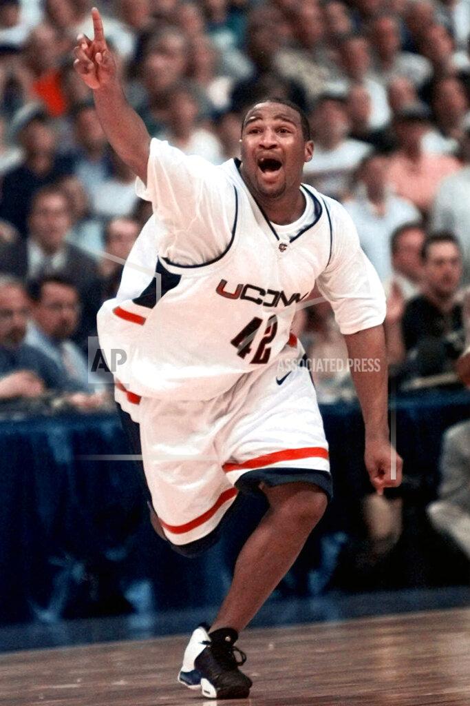 Eric Draper FILE - In this March 29, 1999, file photo, Connecticut's Khalid El-Amin celebrates in the final seconds of the NCAA college basketball Final Four championship game in St. Petersburg, Fla. Connecticut made itself a national power by holding off a dominant Duke team, 77-74, in one of the greatest championship games from NCAA Tournament history. (AP Photo/Eric Draper, File)