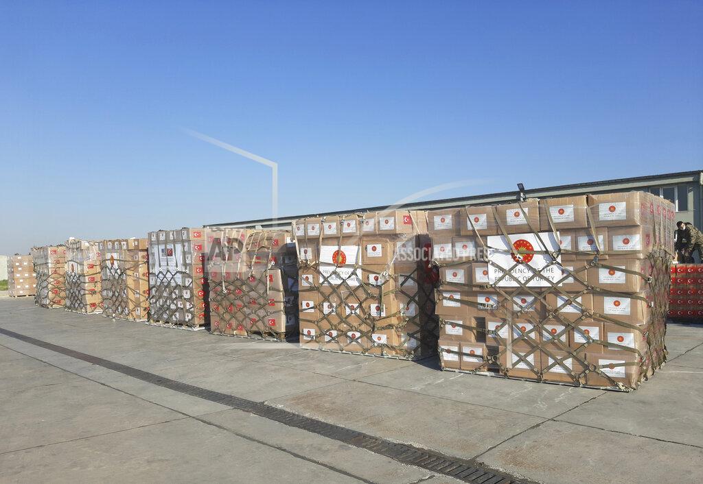 Uncredited In this handout photo provided by the Turkish Defense Ministry, Turkish soldiers prepare to load a military cargo plane with Personal Protection Equipment donated by Turkey to help United States combat the new coronavirus outbreak, at the Etimesgut airport outside Ankara, Turkey, Tuesday, April 28, 2020. Turkey is sending a planeload of surgical masks, N95 masks and hazmat suits to U.S. to help the country battle the coronavirus outbreak.(Turkish Defence Ministry via AP)