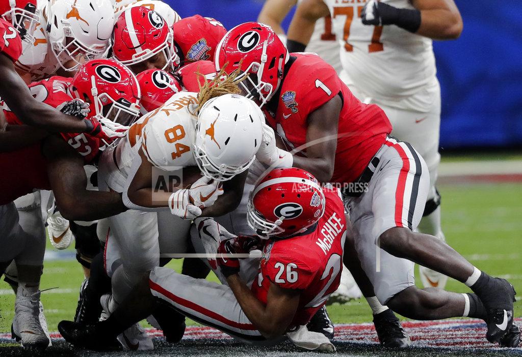 Gerald Herbert Texas wide receiver Lil'Jordan Humphrey (84) is stopped by Georgia defensive back Latavious Brini (36), linebacker Brenton Cox (1) and defensive lineman Tyler Clark (52) during the first half of the Sugar Bowl NCAA college football game in New Orleans, Tuesday, Jan. 1, 2019. (AP Photo/Gerald Herbert)