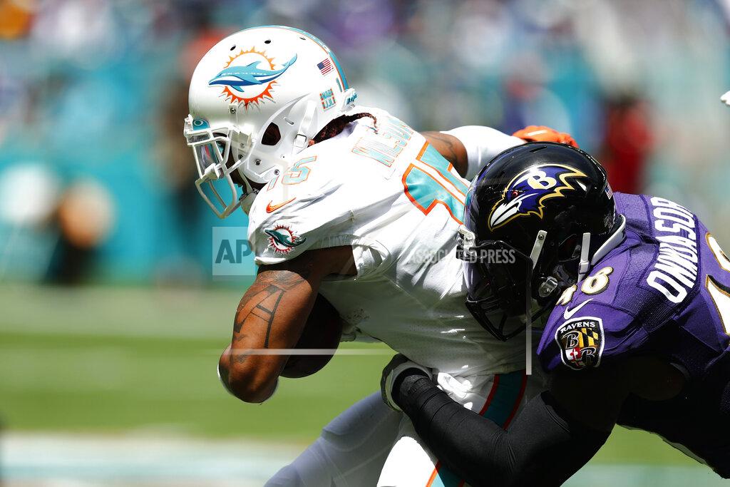 Brynn Anderson FILE - In this Sept. 8, 2019, file photo, Miami Dolphins wide receiver Albert Wilson (15) is tackled by Baltimore Ravens inside linebacker Patrick Onwuasor (48), during the first half at an NFL football game in Miami Gardens, Fla. The new man in the middle of the Ravens defense is Patrick Onwuasor, who arrived in the NFL as an undrafted free agent and carries the not-so-fearsome nickname “Peanut.” Playing the position formerly held by Ray Lewis and C.J. Mosley, Onwuasor wore the headset anointed to the leader of the defense and performed precisely as expected in the opener against Miami last Sunday. He led the Ravens with five tackles, had one of the team’s three sacks and keyed a unit that allowed just 21 yards rushing in a 59-10 victory.(AP Photo/Brynn Anderson, File)