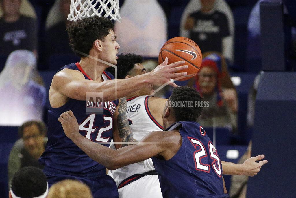 Young Kwak Saint Mary's forward Dan Fotu, left, forward Judah Brown, right, and Gonzaga guard Julian Strawther go after a rebound during the second half of an NCAA college basketball game in Spokane, Wash., Thursday, Feb. 18, 2021. (AP Photo/Young Kwak)