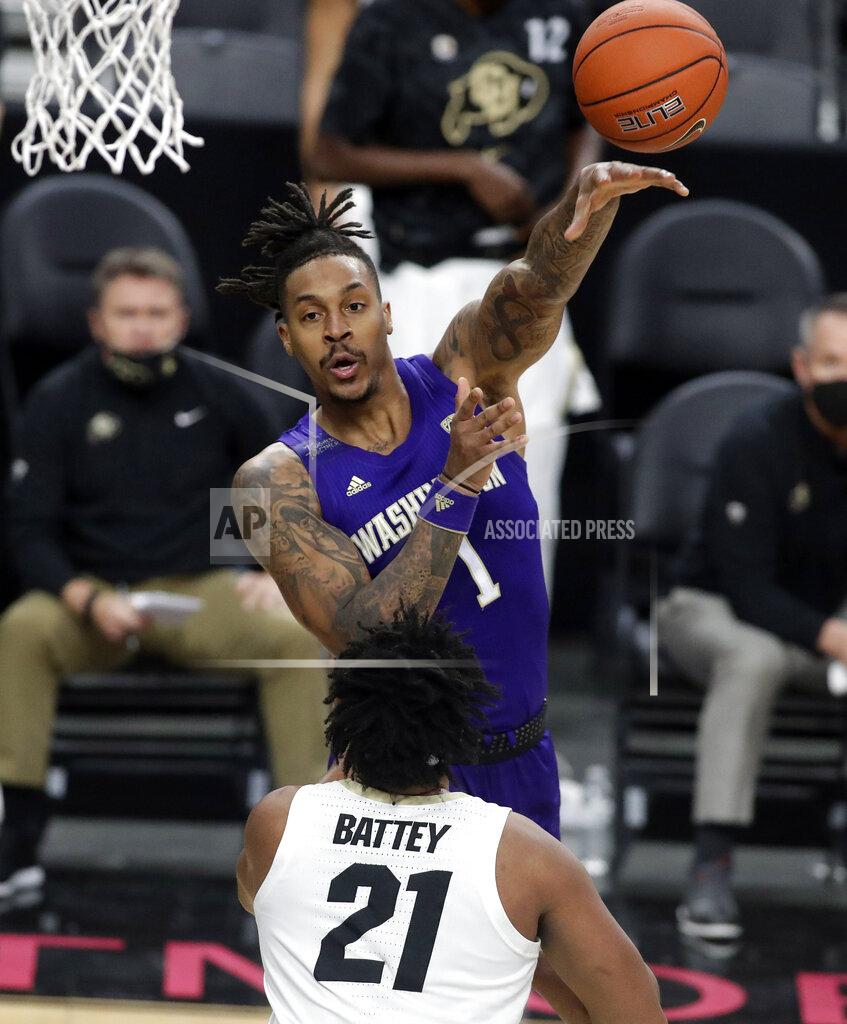 Isaac Brekken Washington's Nate Roberts (1) passes as Colorado's Evan Battey (21) defends during the first half of an NCAA college basketball game, Sunday, Dec. 20, 2020, in Las Vegas. (AP Photo/Isaac Brekken)