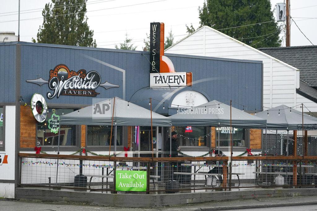 Ted S. Warren Customers are shown at an outdoor seating area at the Westside Tavern, Tuesday, Jan. 5, 2021, in Olympia, Wash. Indoor dining is currently prohibited in the state, and Washington Gov. Jay Inslee was scheduled to give an update on ongoing state efforts to slow the spread of COVID-19 at a news conference Tuesday afternoon. (AP Photo/Ted S. Warren)