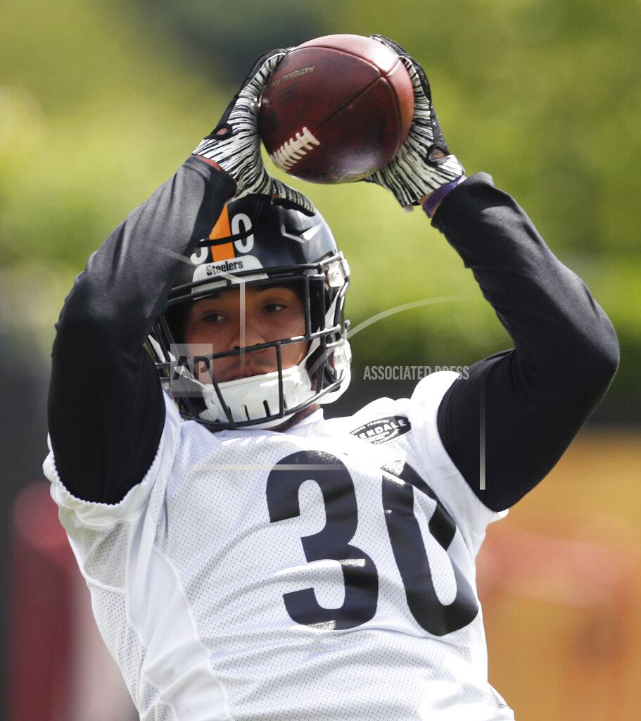Keith Srakocic FILE - This May 21, 2019, file photo shows Pittsburgh Steelers running back James Conner (30) making a catch during an NFL football practice in Pittsburgh. Conner doesn't have to answer questions about Le'Veon Bell anymore. He is firmly entrenched as the starter entering his third season but welcomes the chance to share the load with Jaylen Samuels and rookie Benny Snell Jr. (AP Photo/Keith Srakocic, File)